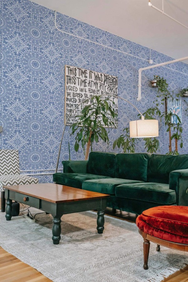 Bold eclectic style living room decorated with Classical Morocco peel and stick wallpaper and emerald green sofa
