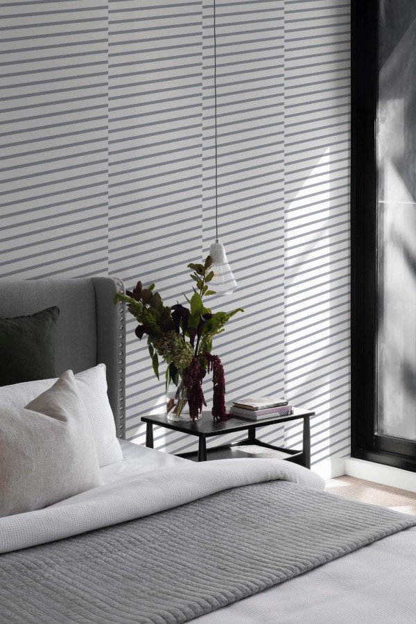 Scandinavian style bedroom decorated with Diagonal Line peel and stick wallpaper