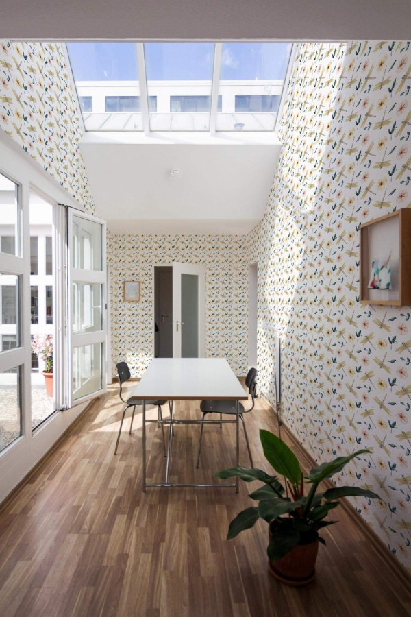 Minimal style dining room next to a balcony decorated with Dragonfly peel and stick wallpaper