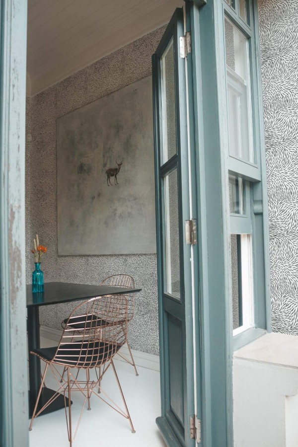 Minimal coastal style cafe decorated with Fur peel and stick wallpaper