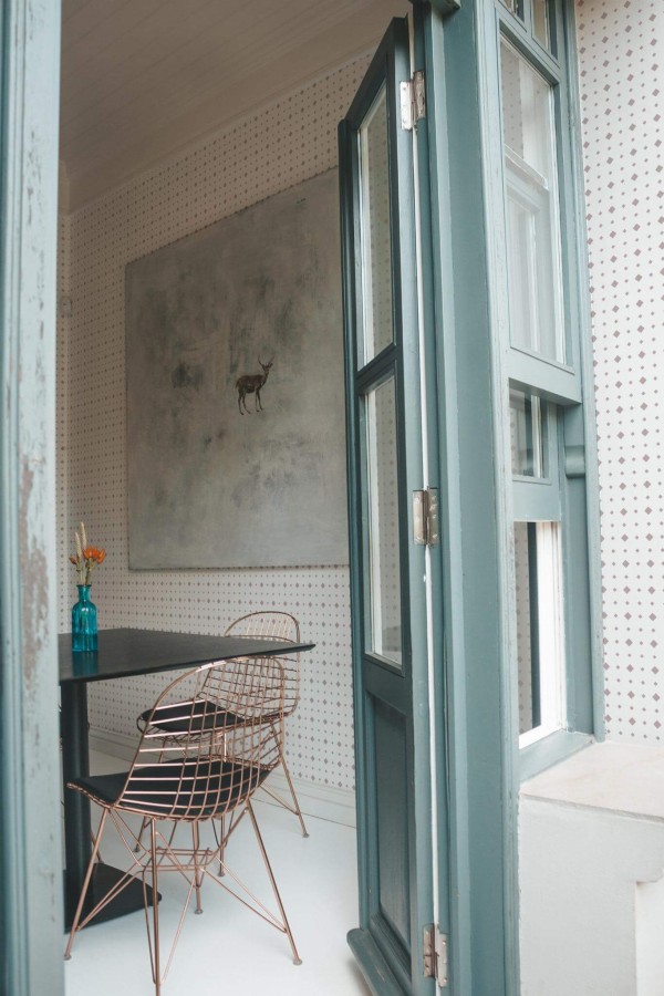 Minimal coastal style cafe decorated with Geometric rhombus dots peel and stick wallpaper