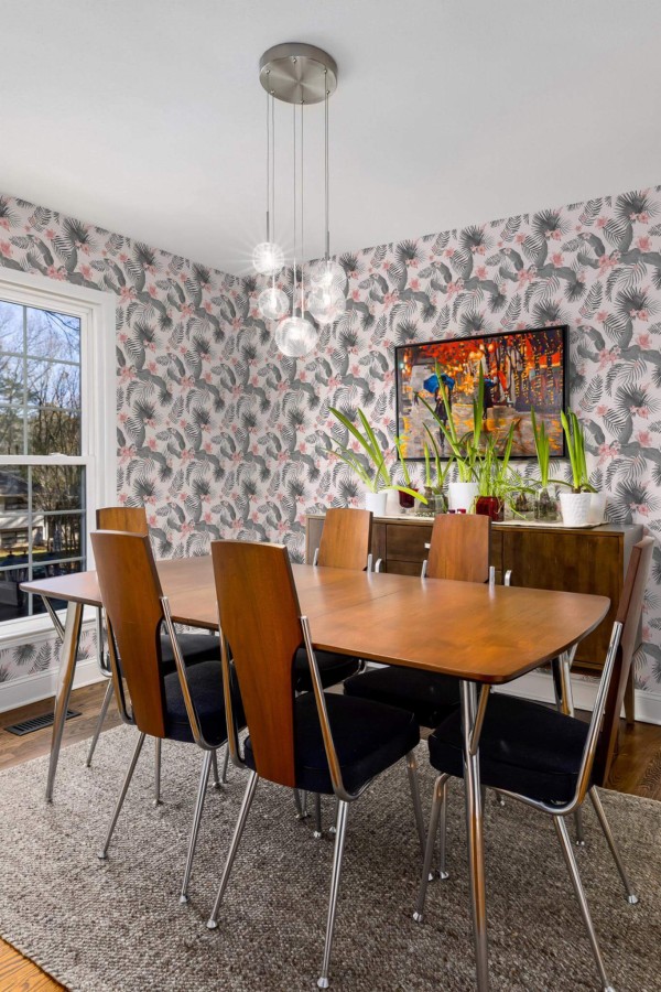 MId-century modern style dining room decorated with Gray and pink tropical peel and stick wallpaper