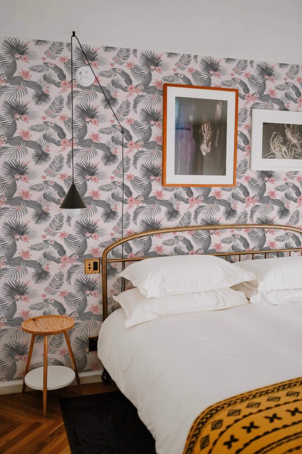 Minimal boho style bedroom decorated with Gray and pink tropical peel and stick wallpaper