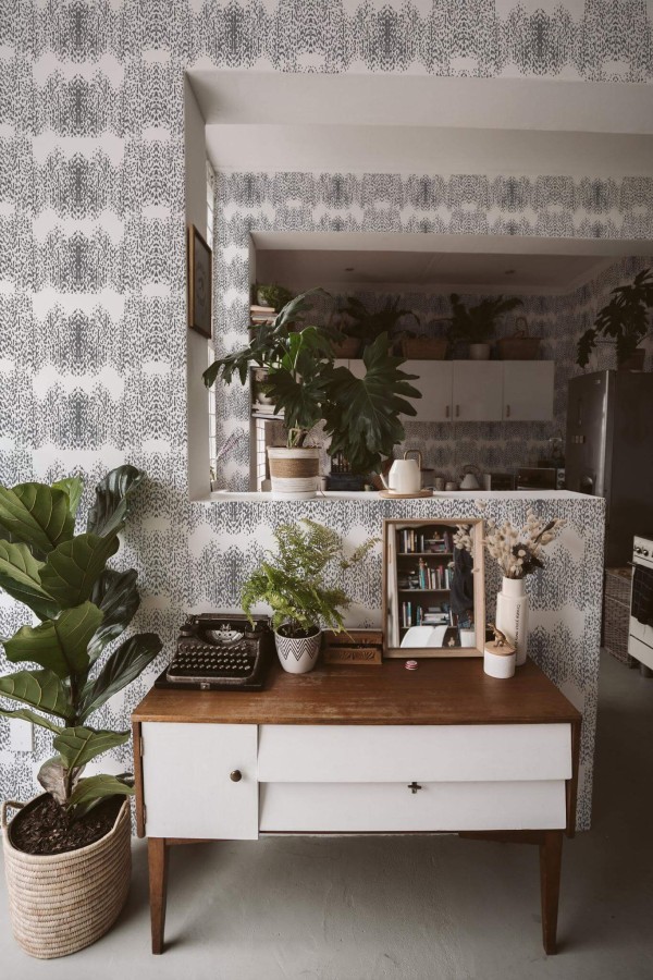 Boho style living room and kitchen decorated with Gray Animal print peel and stick wallpaper and green plants
