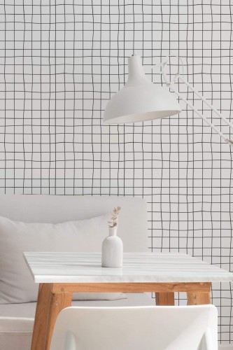 Minimalist dining room interior featuring modern irregular grid peel and stick wallpaper. The design features thin black lines on a crisp white background, adding dynamic geometric interest. The space includes a sleek white table, minimalist seating, and a contemporary white lamp, creating an elegant and airy atmosphere.