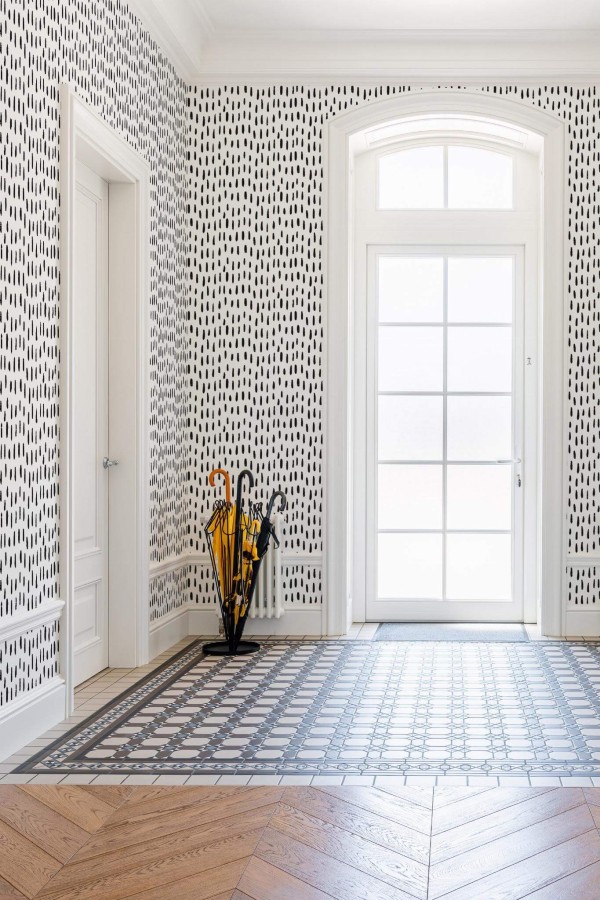 Minimal farmhouse style entryway decorated with Hand drawn spots peel and stick wallpaper