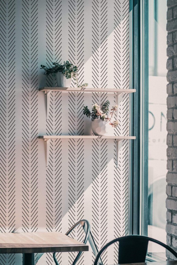 Industrial style cafe decorated with Herringbone peel and stick wallpaper