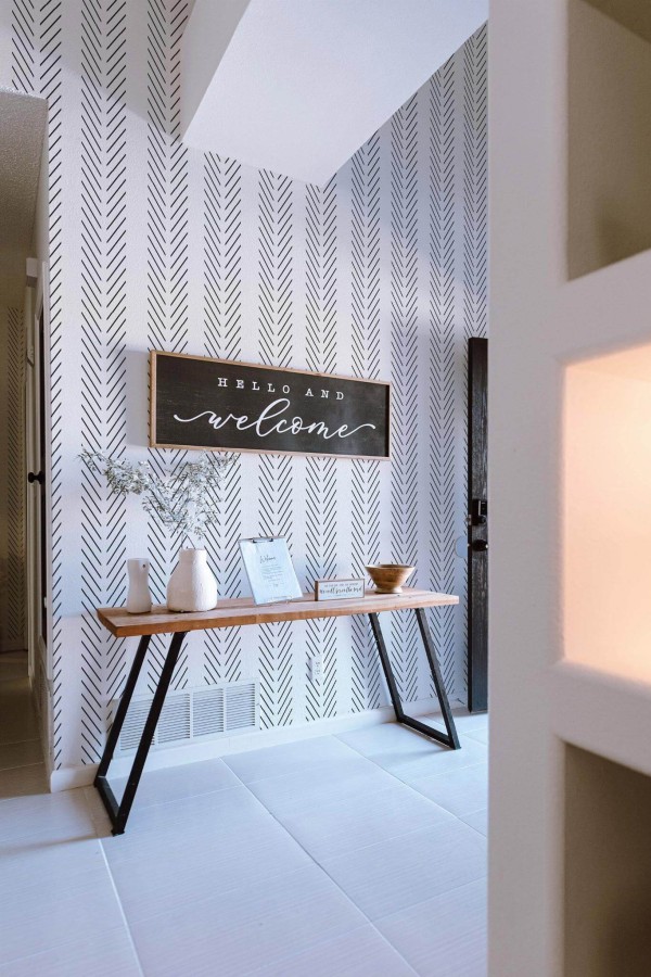 Minimal farmhouse style entryway decorated with Herringbone peel and stick wallpaper