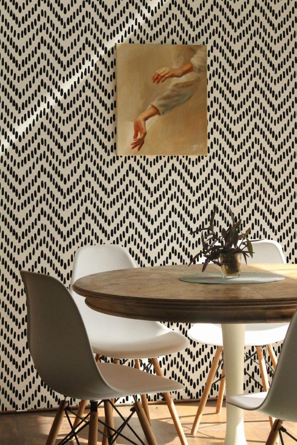 Scandinavian farmhouse style dining room decorated with Ikat chevron peel and stick wallpaper