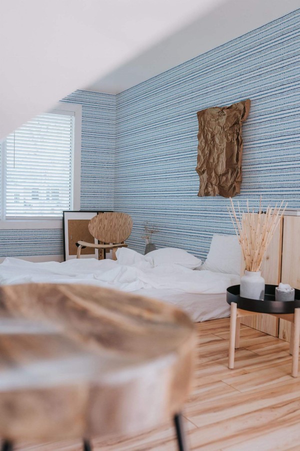 Boho style bedroom decorated with Ikat lines peel and stick wallpaper