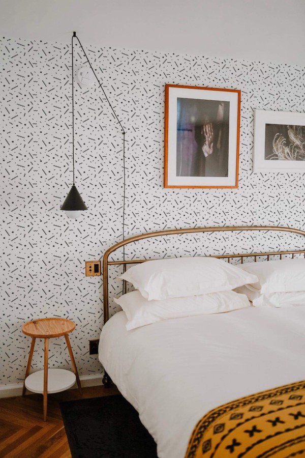 Minimal boho style bedroom decorated with Memphis peel and stick wallpaper