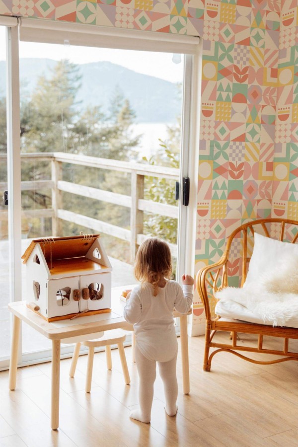 Boho gender neutral style kids room decorated with Multicolor geometric collage peel and stick wallpaper