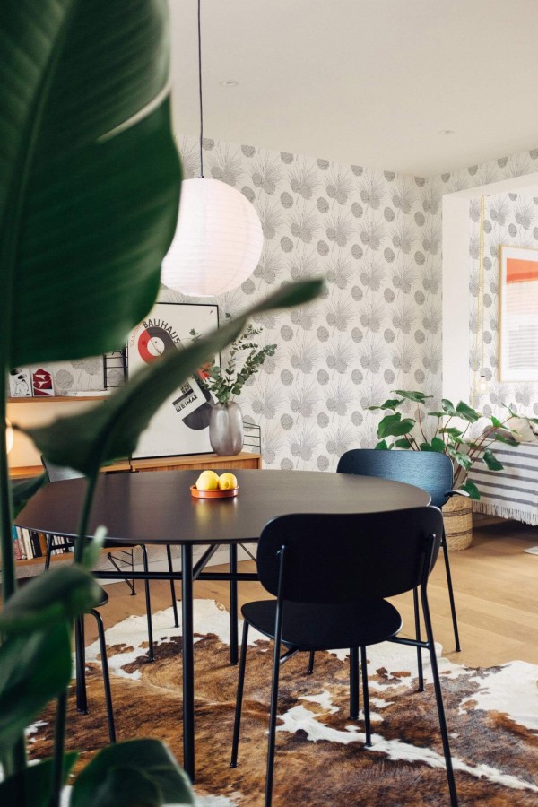 Scandinavian style dining room decorated with Pine branch peel and stick wallpaper