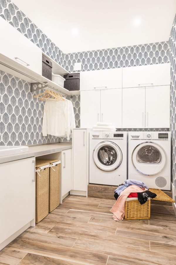 Scandinavian style laundry room decorated with Scandi Leaf peel and stick wallpaper