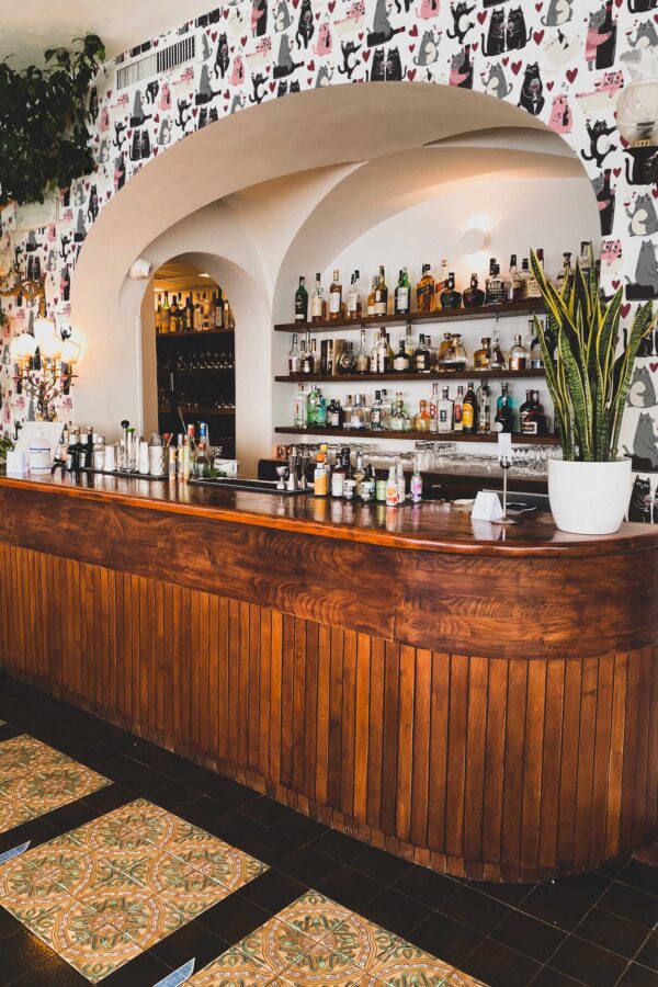 Fancy Walls peel and stick wallpaper with cute wine-loving cats