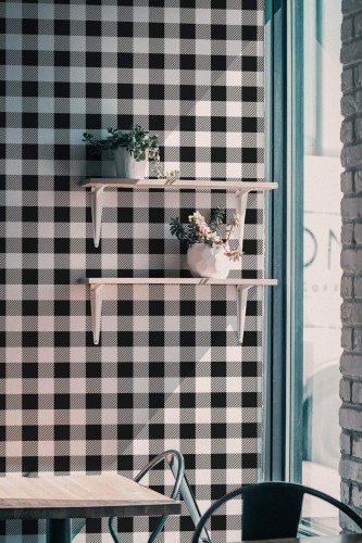 Industrial style cafe decorated with Tartan peel and stick wallpaper