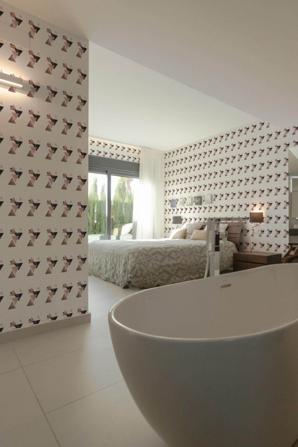 Modern style bedroom with open bathroom decorated with Triangle peel and stick wallpaper