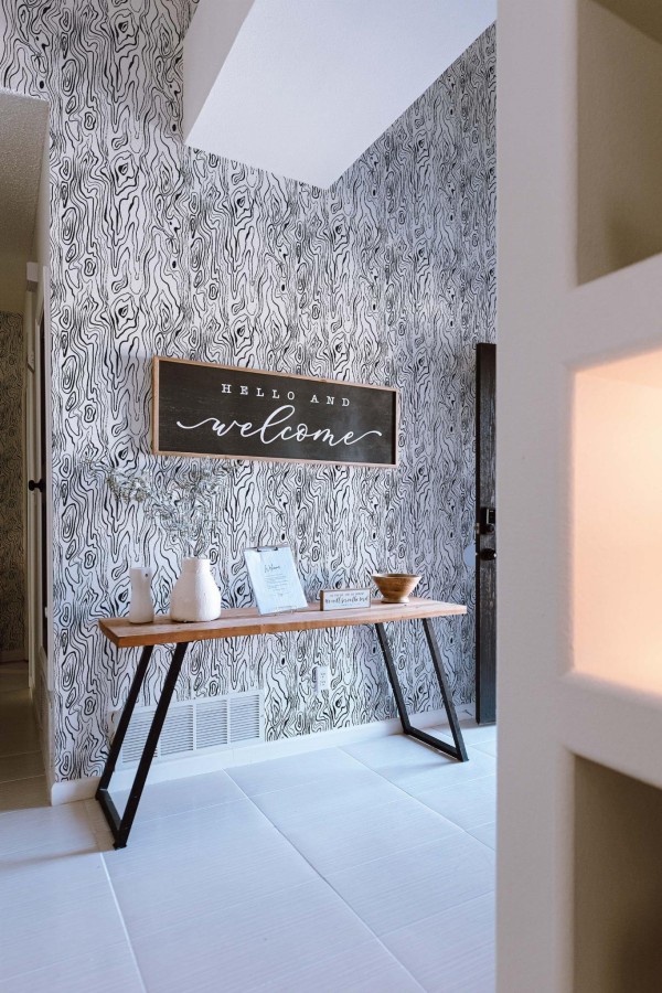 Minimal farmhouse style entryway decorated with Wood pattern peel and stick wallpaper