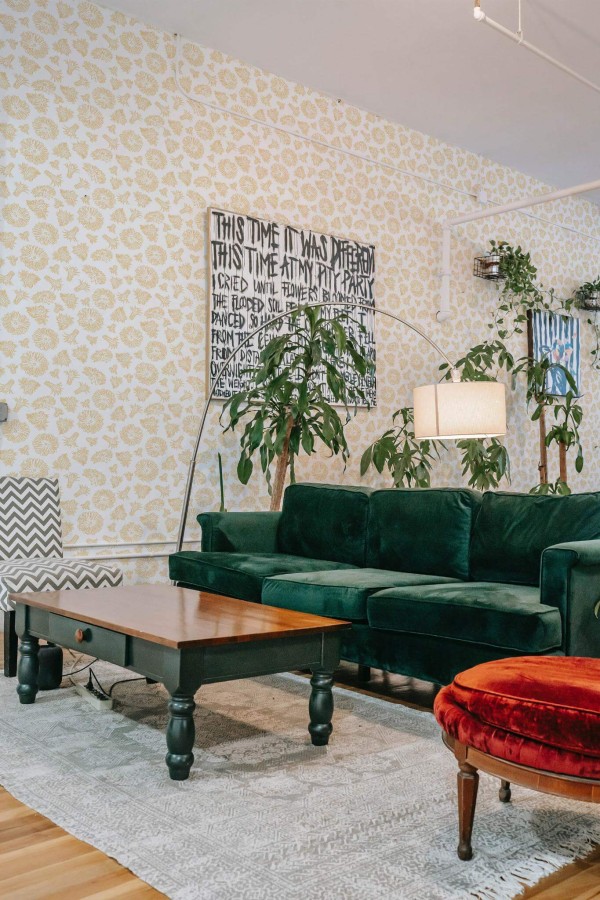 Bold eclectic style living room decorated with Yellow Dandelion peel and stick wallpaper and emerald green sofa