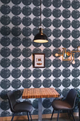 Fancy Walls removable wallpaper with seamless bold full moon pattern in gray.