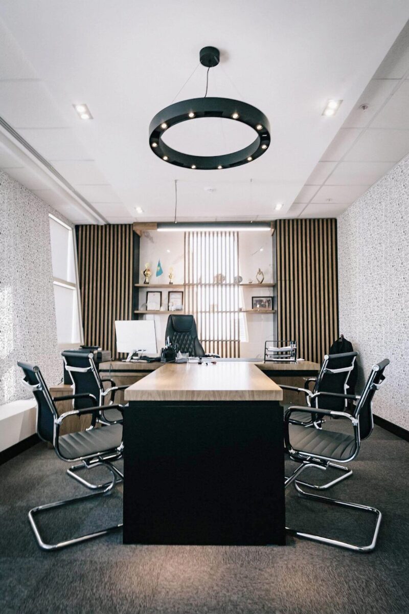 Monochromatic study bits peel and stick wallpaper in a modern home office with black chairs