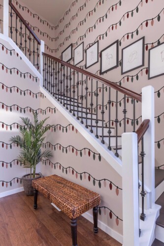 Self-adhesive wallpaper from Fancy Walls featuring festive pastel string lights