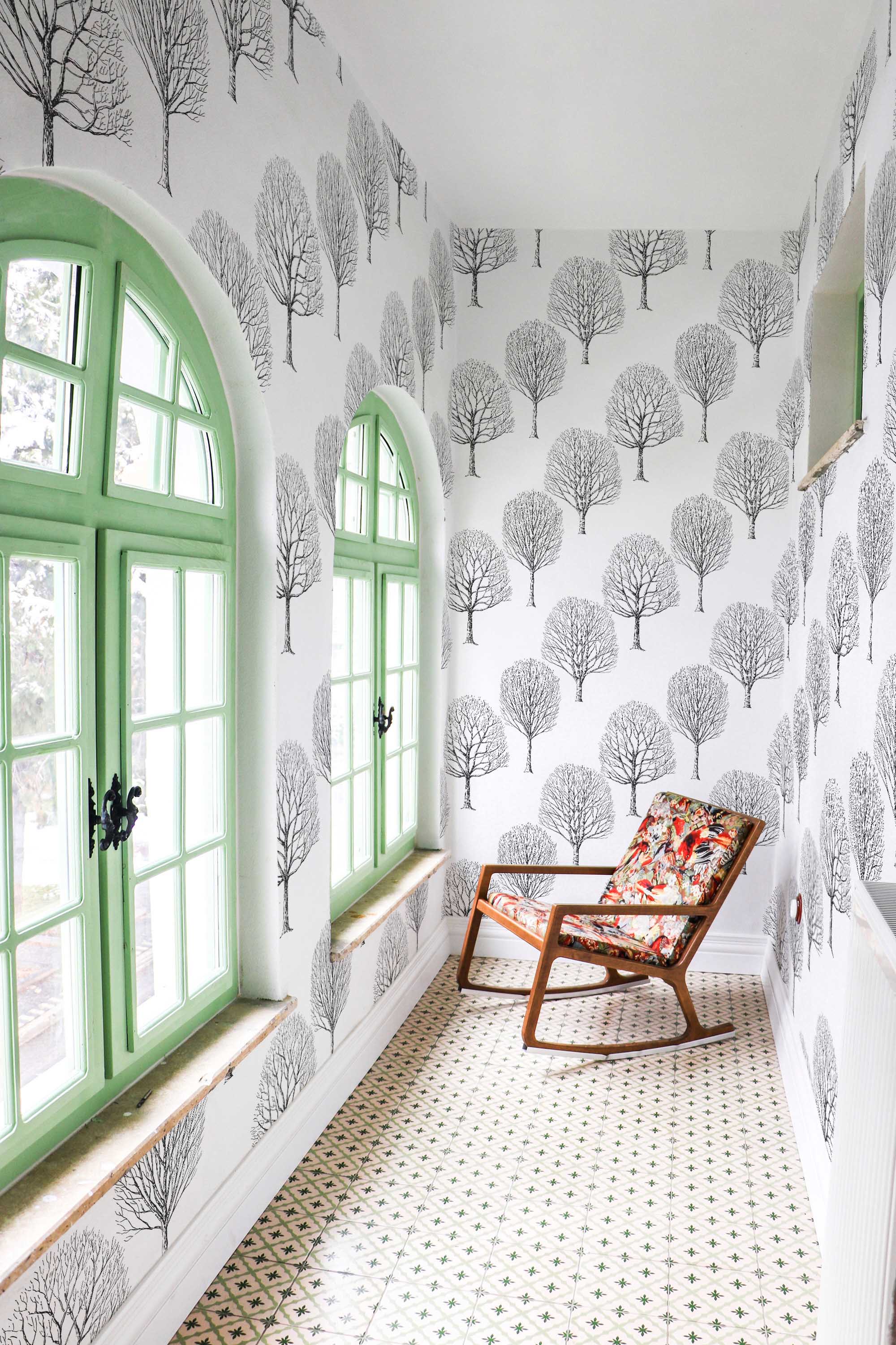 Fancy Walls traditional wallpaper with tranquil black and white birches for nature-themed interiors.
