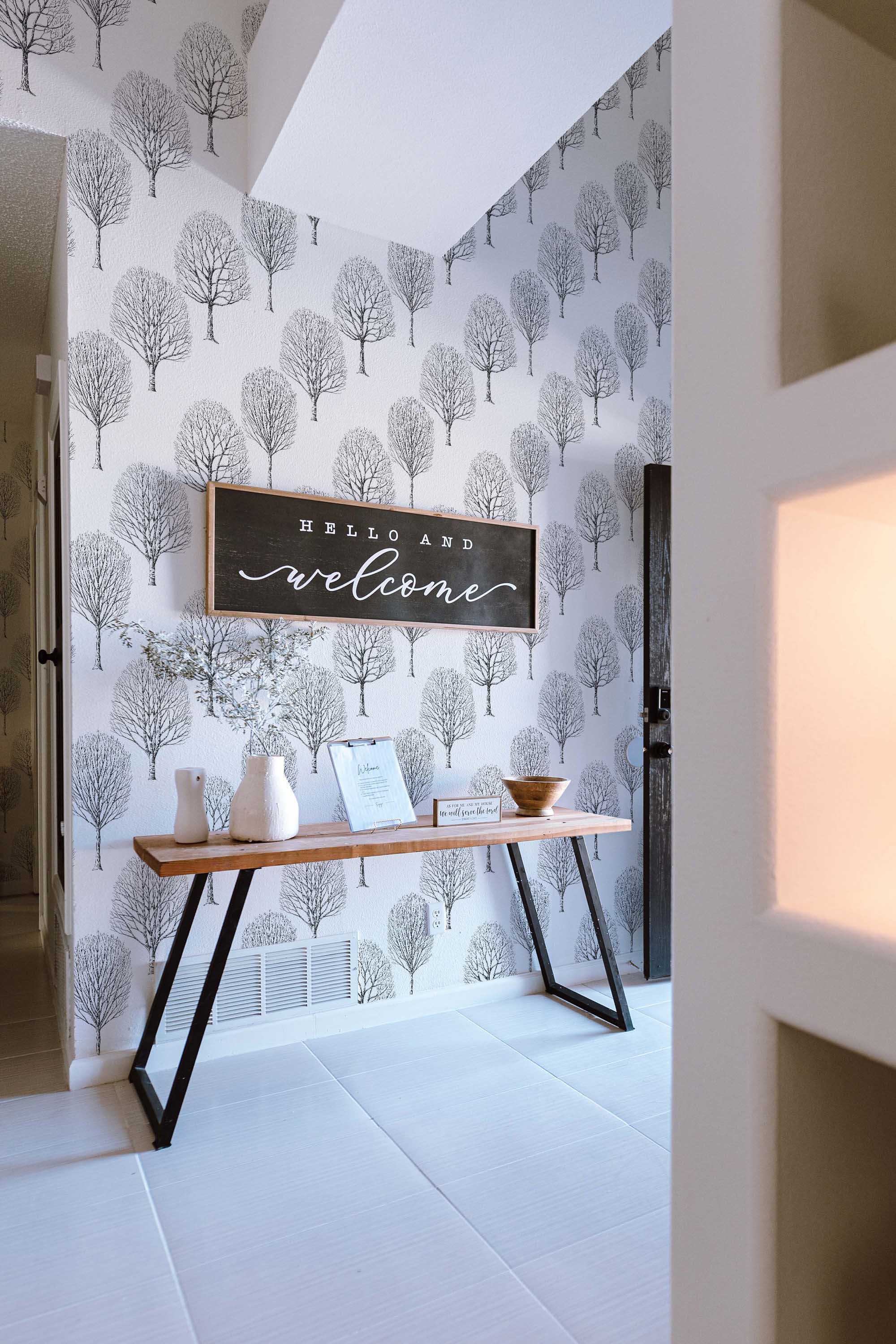 Fancy Walls self-adhesive wallpaper featuring minimalist birch silhouettes in black and white for serene interiors.