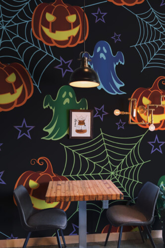 Haunted Glow wall mural by Fancy Walls featuring glowing pumpkins, ghosts, and spider webs on a dark background perfect for Halloween décor peel and stick wall mural for festive interiors