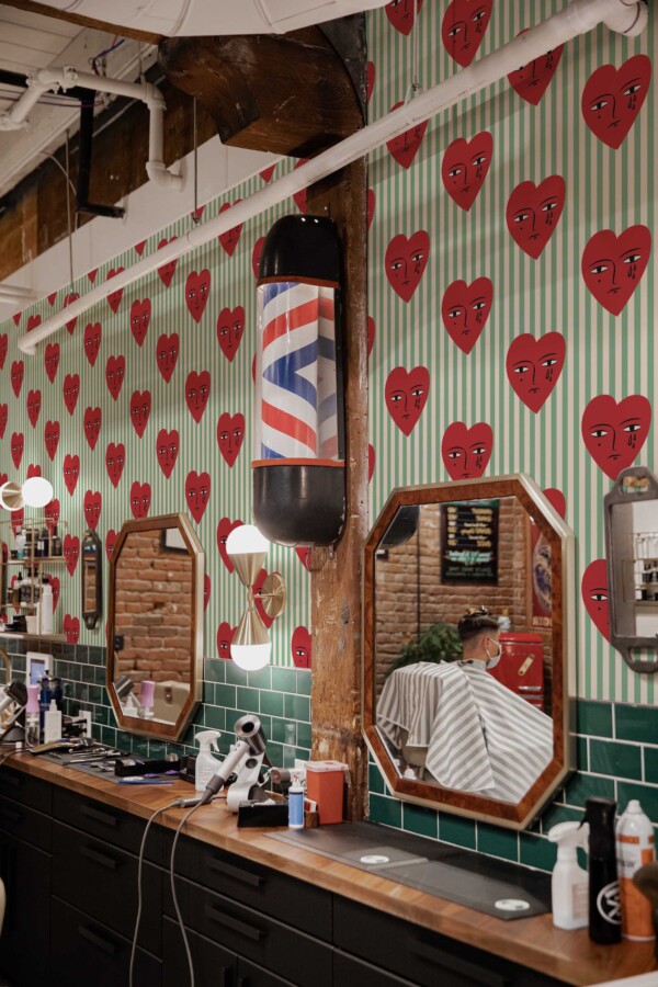 Fancy Walls peel and stick wallpaper with red crying hearts on sage green stripes.