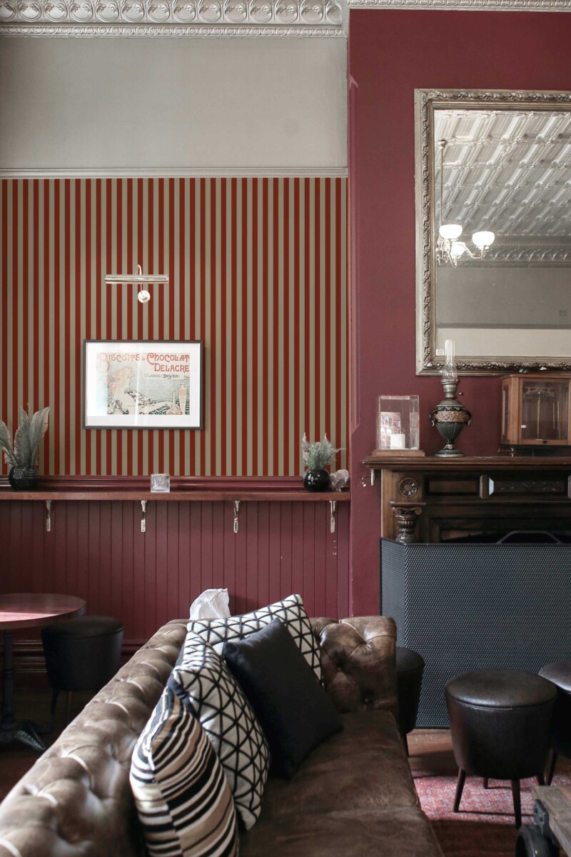 Fancy Walls peel and stick wallpaper with bold red and brown Christmas stripes for a refined holiday look.