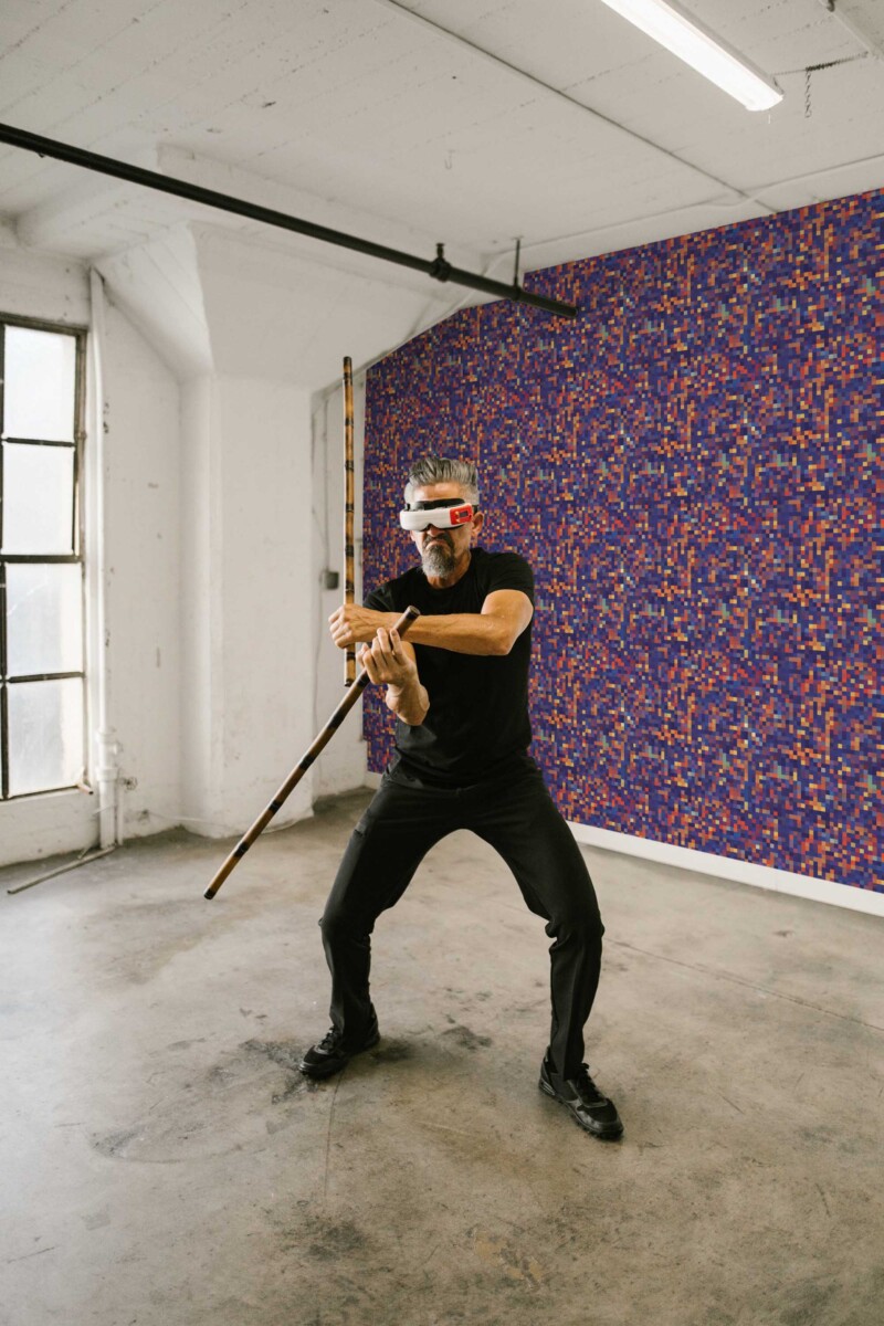 Fancy Walls peel and stick wallpaper with bold purple red and orange pixel pattern.