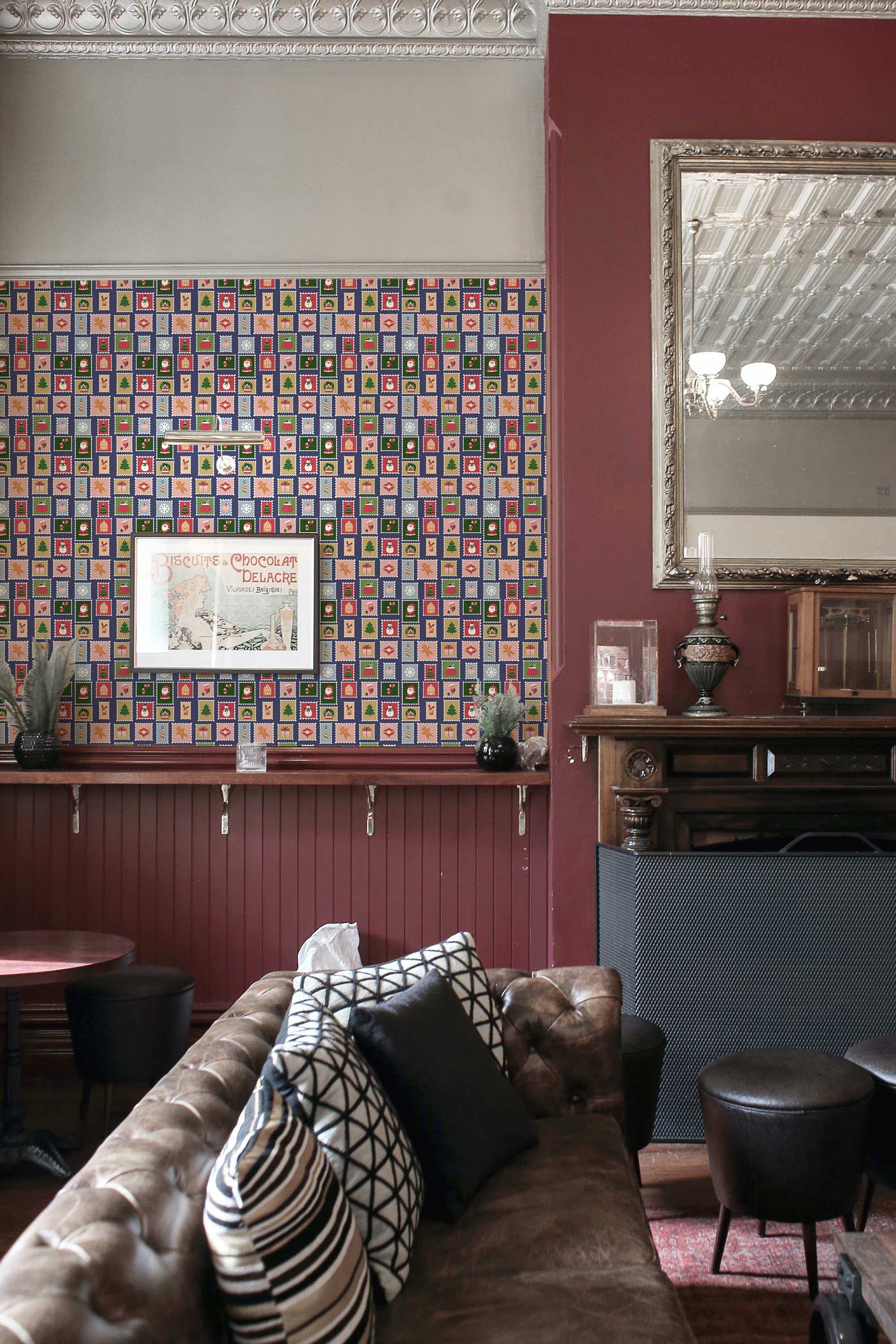 Fancy Walls self-adhesive wallpaper with tiled holiday postage stamp pattern in soft green tones.