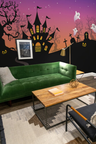 Haunted Twilight Horizon wall mural by Fancy Walls featuring a dark Halloween landscape with glowing castle windows, purple-orange sky, and floating ghosts peel and stick wall mural design
