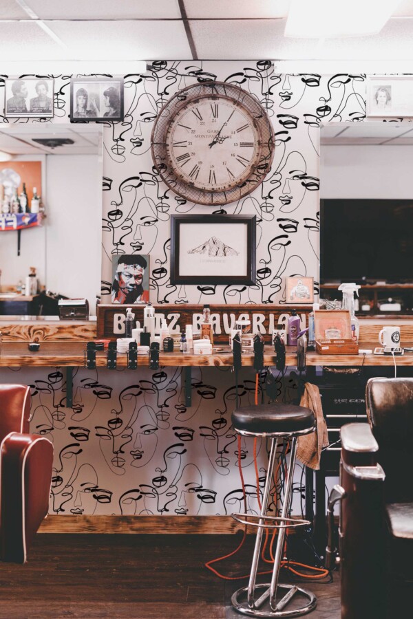 Fancy Walls traditional wallpaper featuring minimalist abstract faces in line art style.