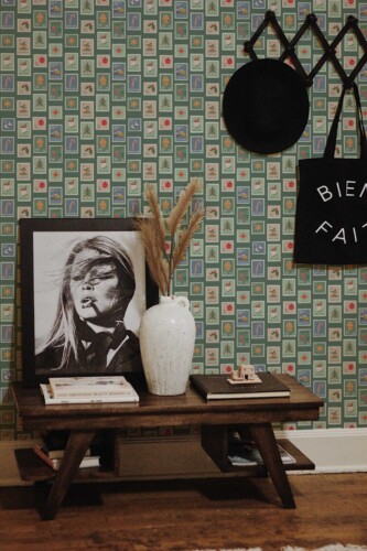 Fancy Walls traditional wallpaper with green squares and nostalgic winter stamp illustrations.