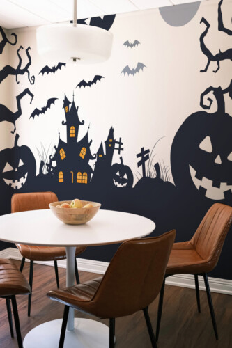 Fancy Walls Spooky Pumpkins printed wall mural showing a lively Halloween landscape with bats, trees, and glowing jack o lanterns wall mural printing quality