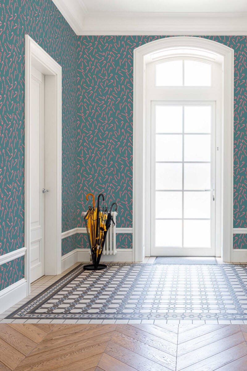 Fancy Walls removable wallpaper showcasing red and white candy canes on a teal background. Sweet Stripes Wallpaper peel and stick or non-pasted PVC-free and eco-friendly wallpaper for walls