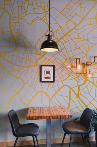 Fancy Walls Minimalistic Rome Map peel and stick wall mural featuring a golden map on a gray background.