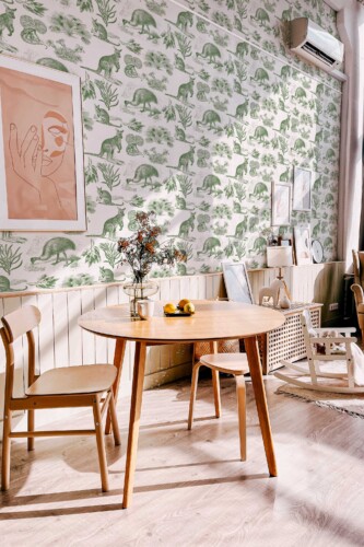 Fancy Walls peel and stick wallpaper featuring soft green Australian flora and fauna sketches.