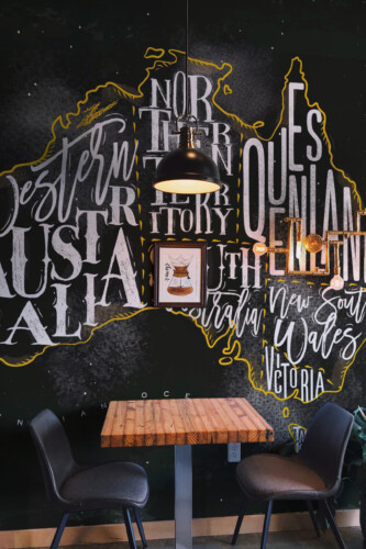 Fancy Walls Chalkboard Australia Map peel and stick wall mural with chalk-style region lettering on a dark background.