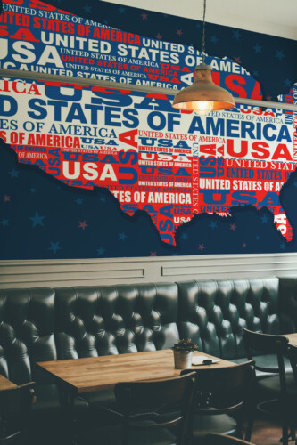 Fancy Walls Creative USA Map peel and stick wall mural with modern red white blue typography map on dark background.