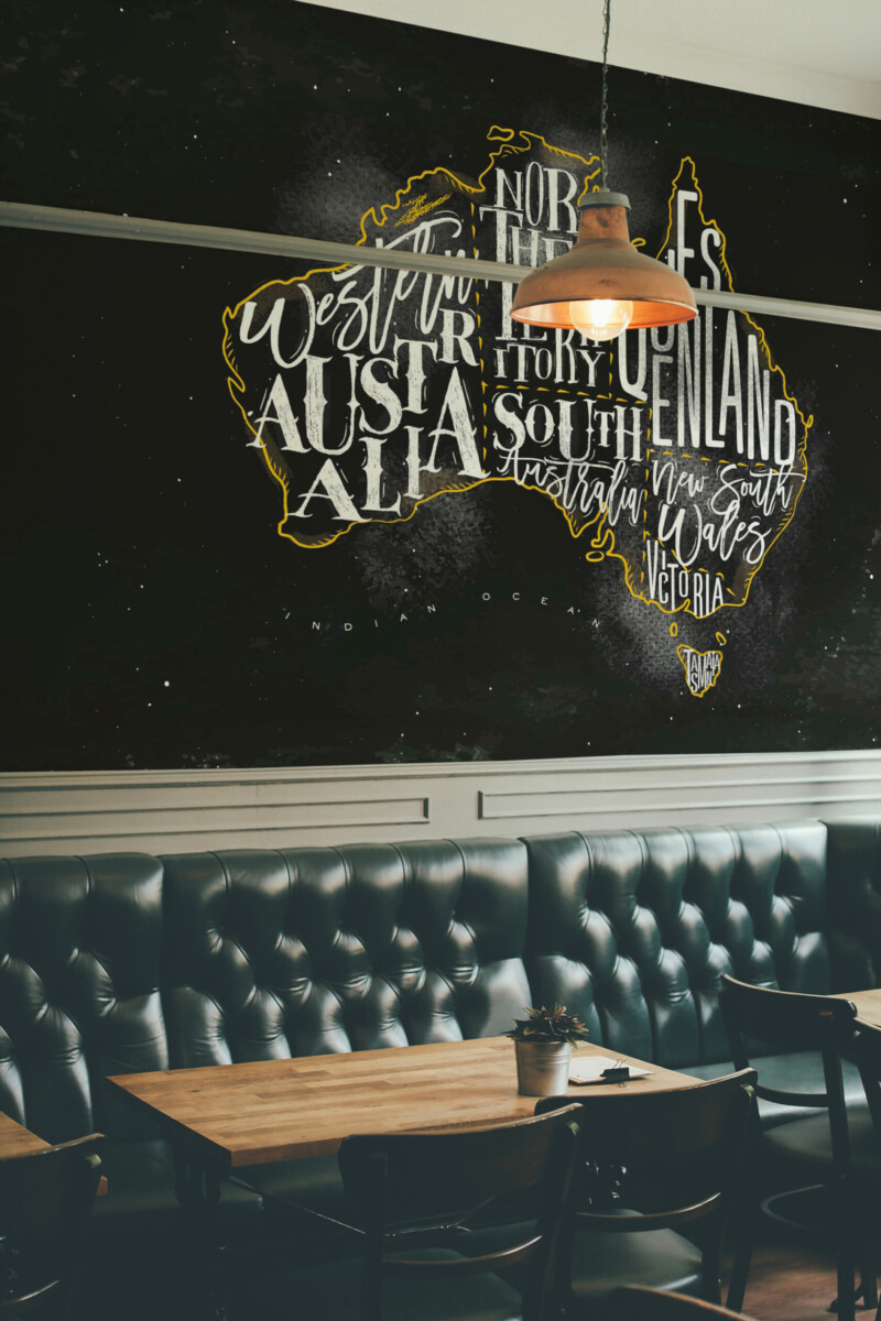 Fancy Walls Chalkboard Australia Map wall mural printing with artistic state names on a black chalkboard texture.