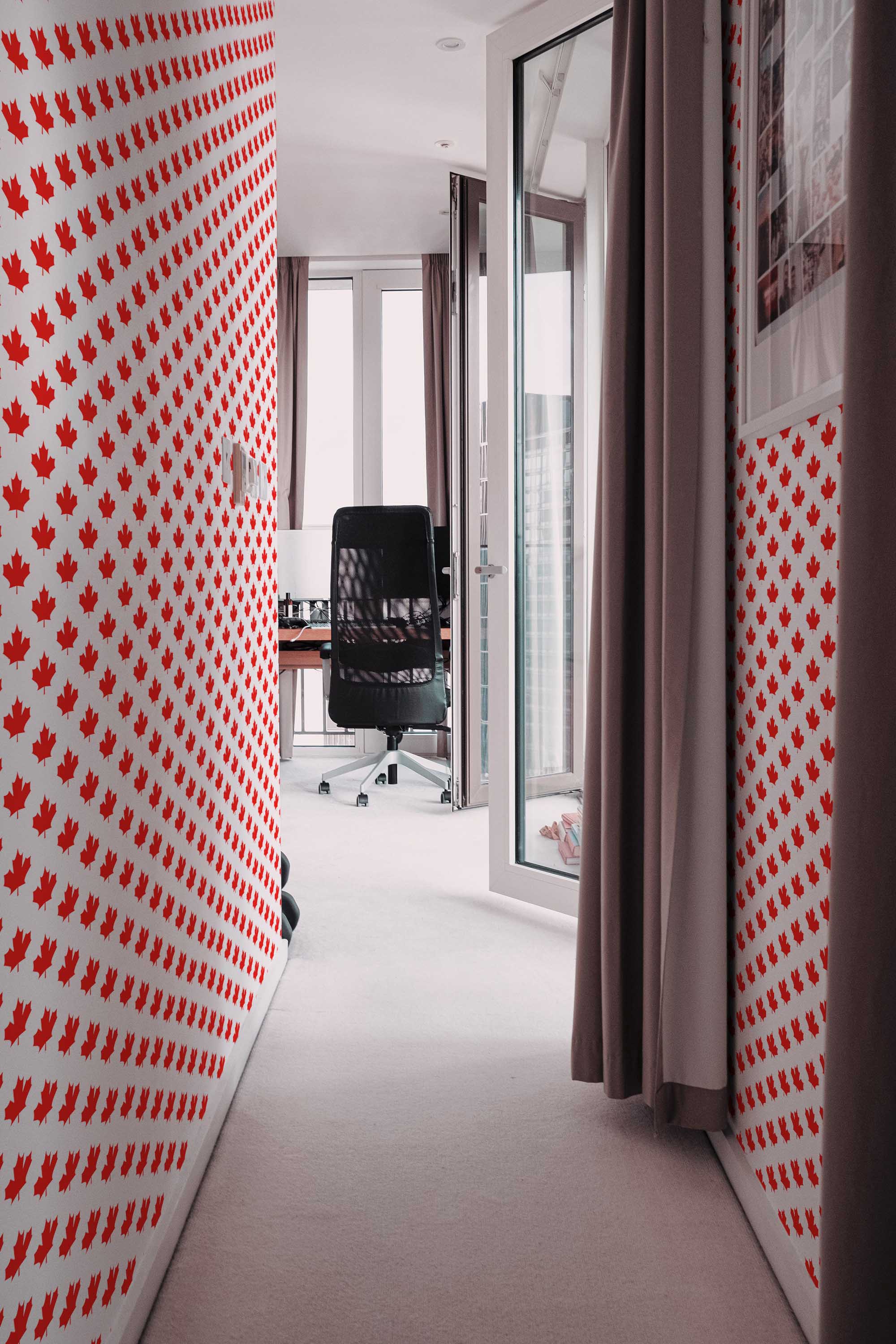 Fancy Walls peel and stick wallpaper with bright red Canadian maple leaf pattern.