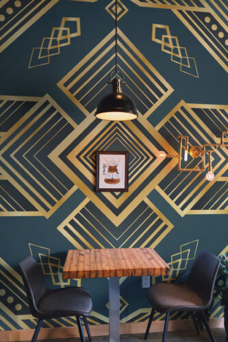 Fancy Walls Emerald Deco Rhombus peel and stick wall mural with bold geometric gold and green Art Deco lines.