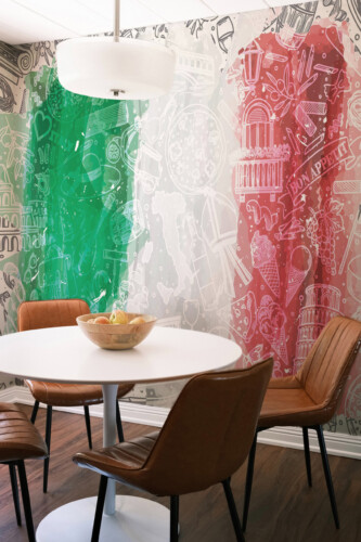 Fancy Walls Italian Living Charm peel and stick wall mural featuring artistic Italy flag brushstrokes and cultural icons.
