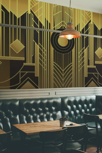 Fancy Walls Radiant Art Deco Geometry peel and stick wall mural with bold geometric lines in gold and black.
