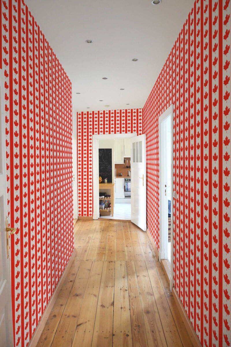 Fancy Walls self-adhesive wallpaper featuring bold red maple flag stripe accents.