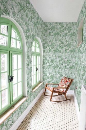 Fancy Walls removable wallpaper showcasing fresh tropical leaves in gentle green tones for a relaxing room update.
