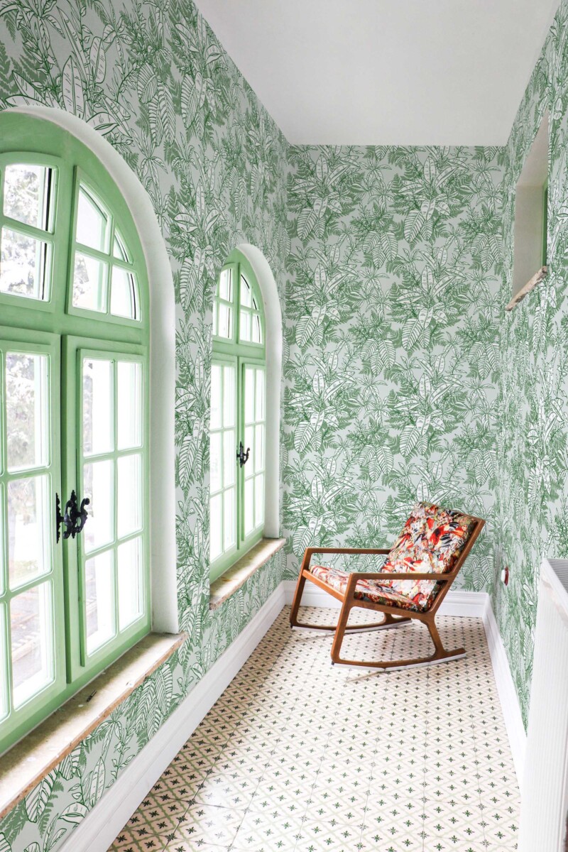 Fancy Walls removable wallpaper showcasing fresh tropical leaves in gentle green tones for a relaxing room update.